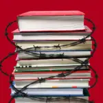 стопка книг перевязана колючей проволокой