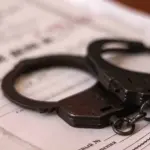 папка "уголовное дело" и на ней лежат наручники